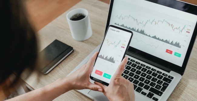 Forex trader using crypto exchange mobile phone app for investment and stock market analysis at hedge fund office – Focus on screen